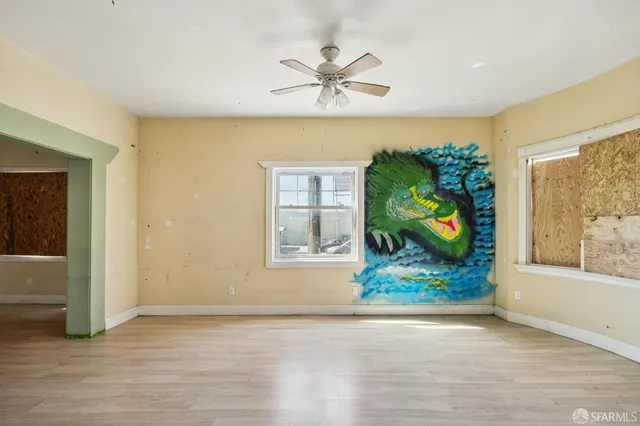 wooden floor in an empty room with a window