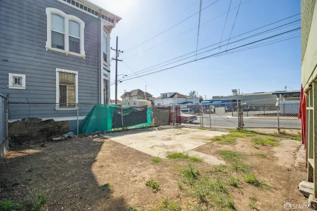 a view of a house with a wooden fence