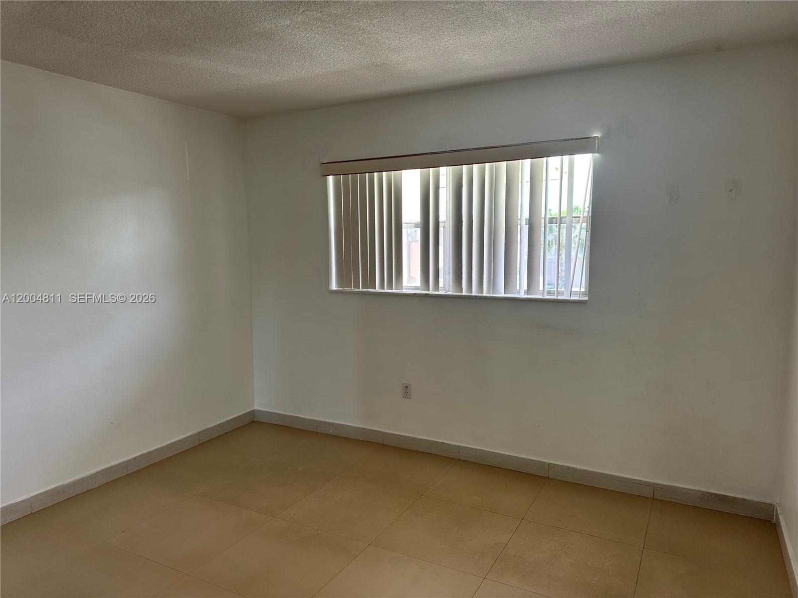 7424 Southwest 82nd Street, Unit D216 Miami, FL 33143 - Photo 5 of 9 an empty room with a window