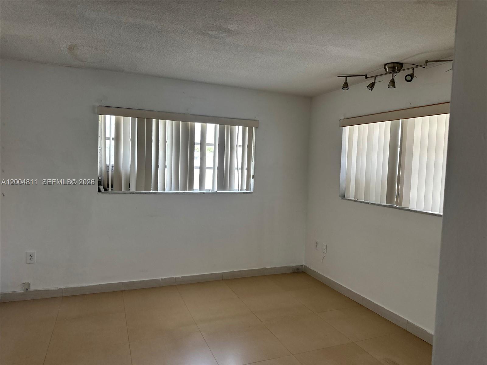 7424 Southwest 82nd Street, Unit D216 Miami, FL 33143 - Photo 7 of 9 an empty room with windows