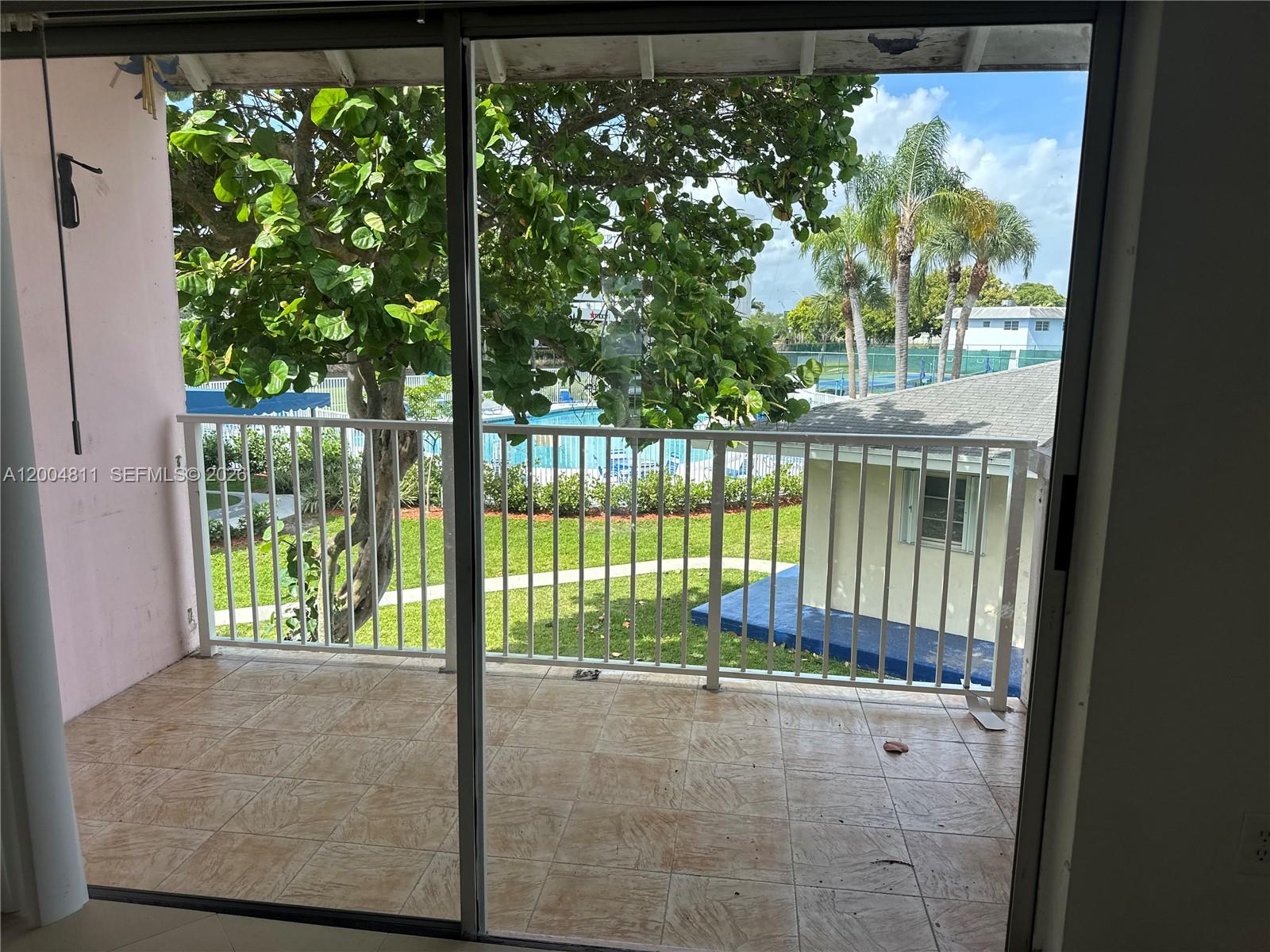 7424 Southwest 82nd Street, Unit D216 Miami, FL 33143 - Photo 8 of 9 a view of a small yard from a balcony