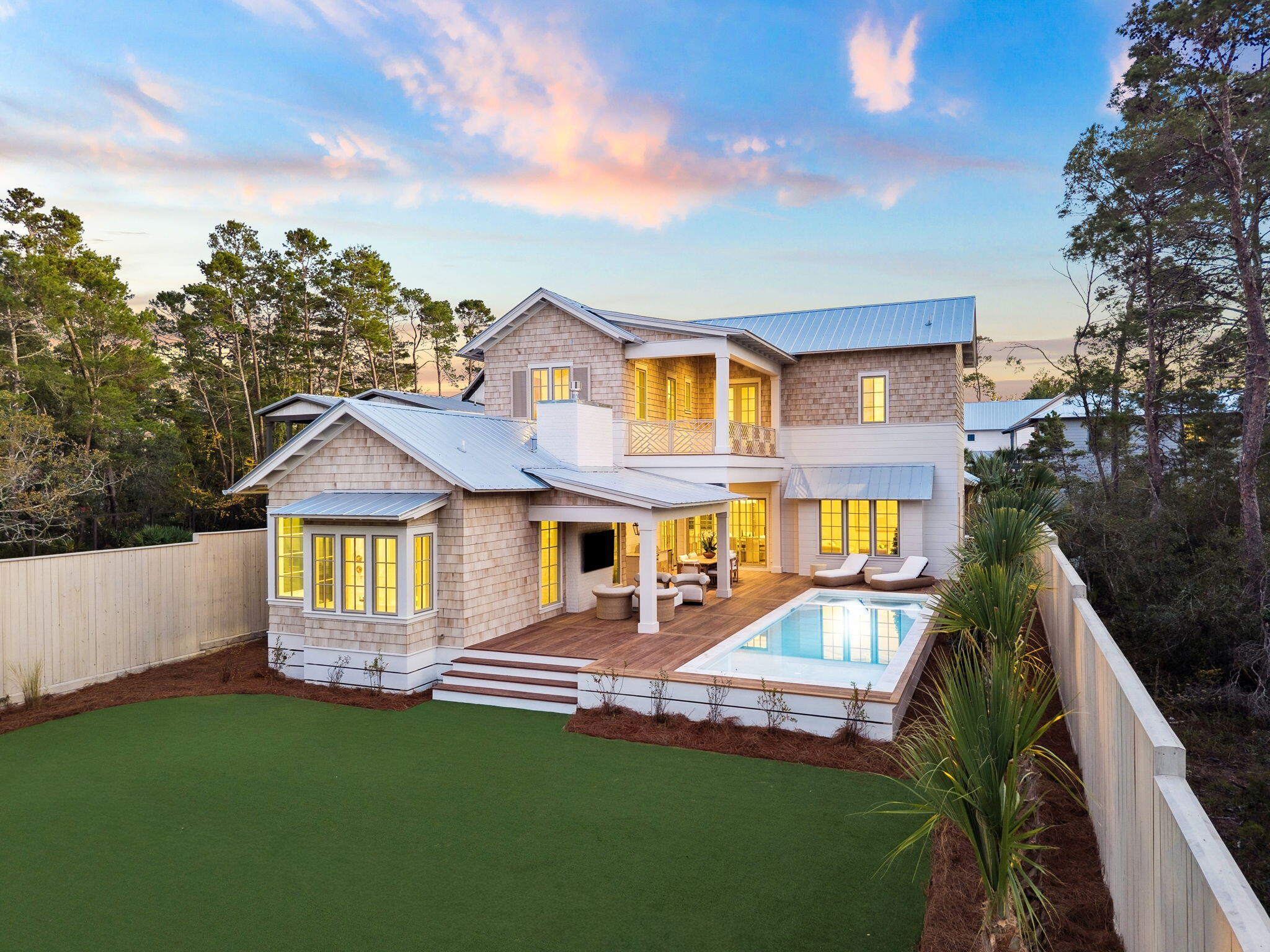 a front view of a house with a garden and yard
