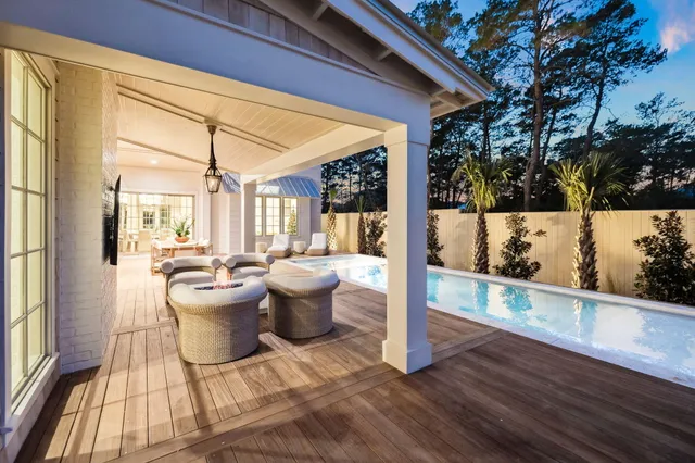 a view of a dining room with furniture a chandelier and wooden floor