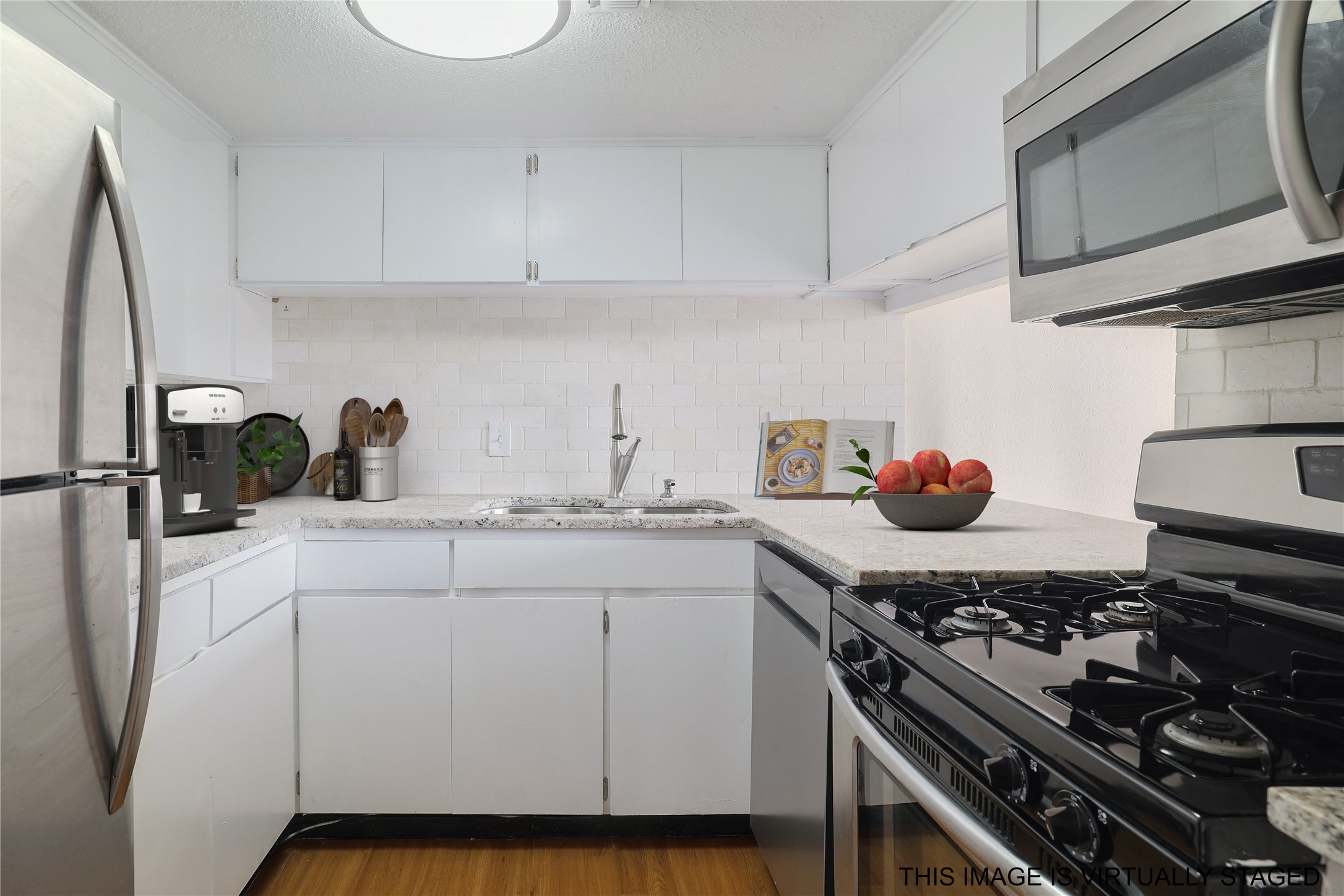1800 Lavaca Street, Unit A508 Austin, TX 78701 - Photo 5 of 25 Kitchen with granite counter, stainless appliances. Virtually Staged