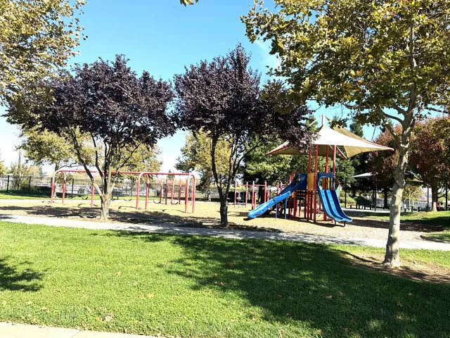 a view of park with swings and slides