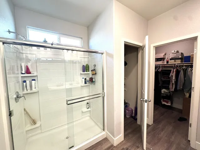 a bathroom with a shower and a glass door