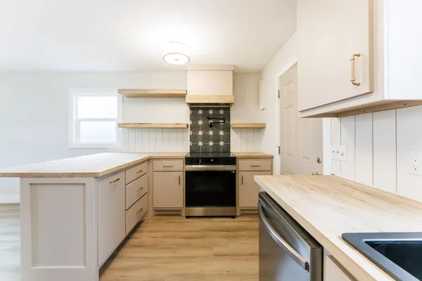 a kitchen with a stove and a sink