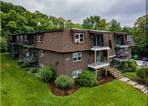 a view of house with a yard and furniture