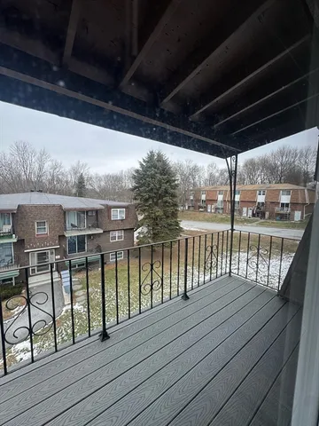 a view of a balcony with wooden floor