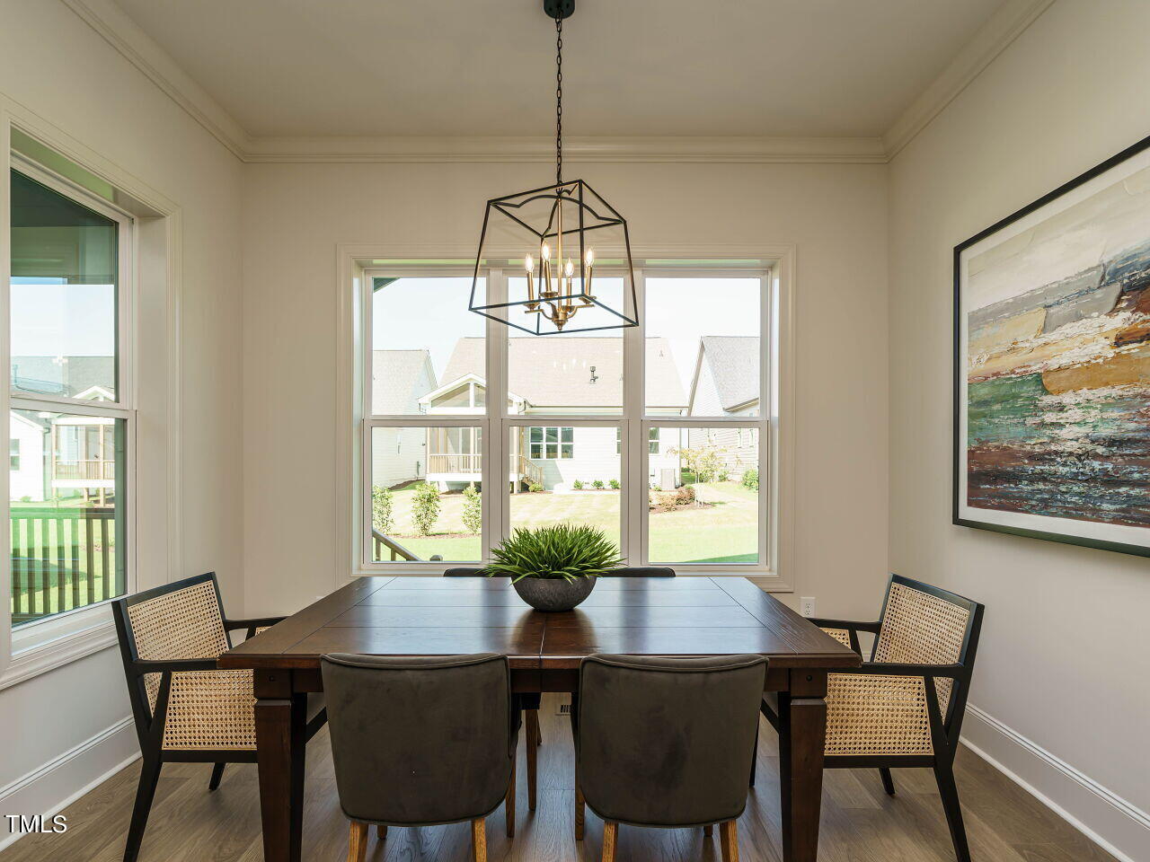 1528 Level Stream Road Wendell, NC 27591 - Photo 11 of 46 a dining room with furniture a chandelier and wooden floor