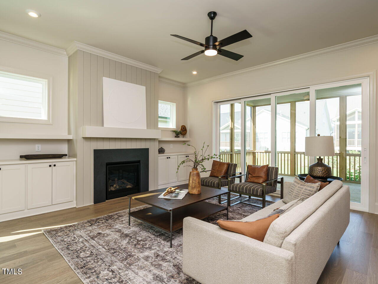 1528 Level Stream Road Wendell, NC 27591 - Photo 15 of 46 a living room with furniture a fireplace and a floor to ceiling window