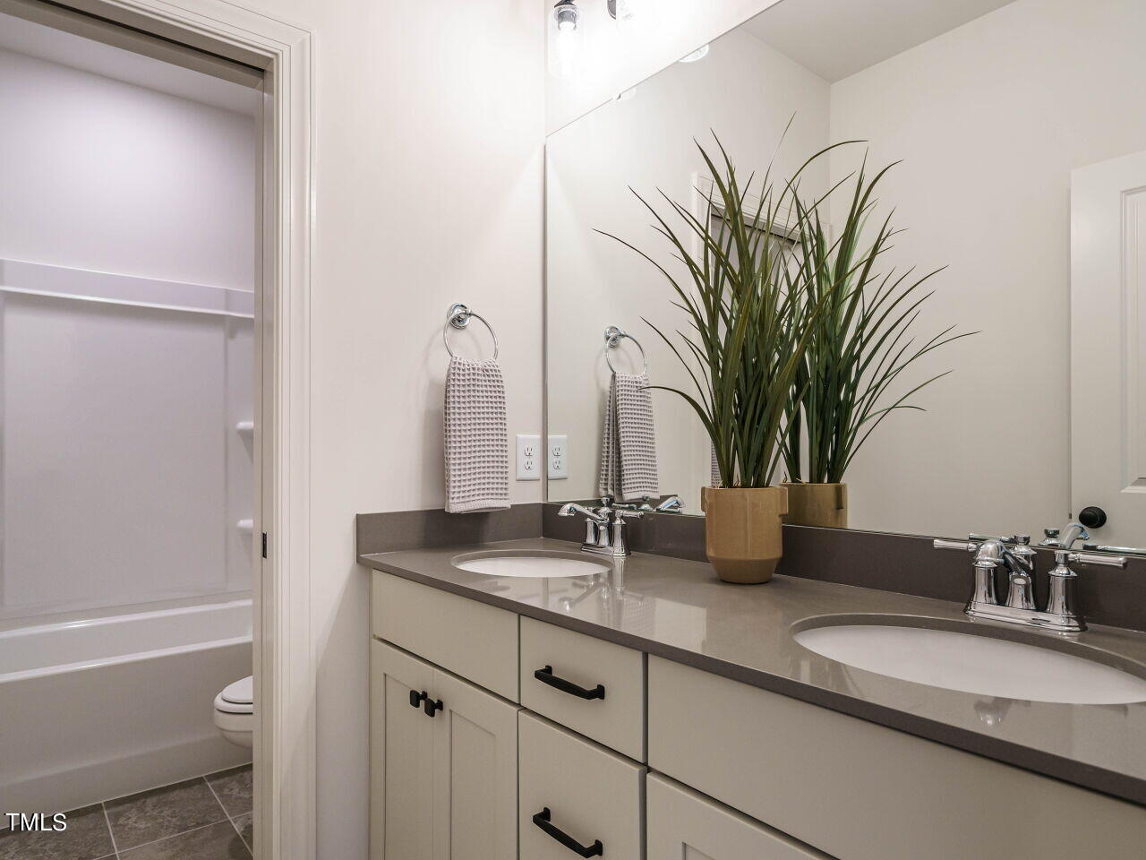 1528 Level Stream Road Wendell, NC 27591 - Photo 23 of 46 a bathroom with a granite countertop sink a mirror and a bathtub