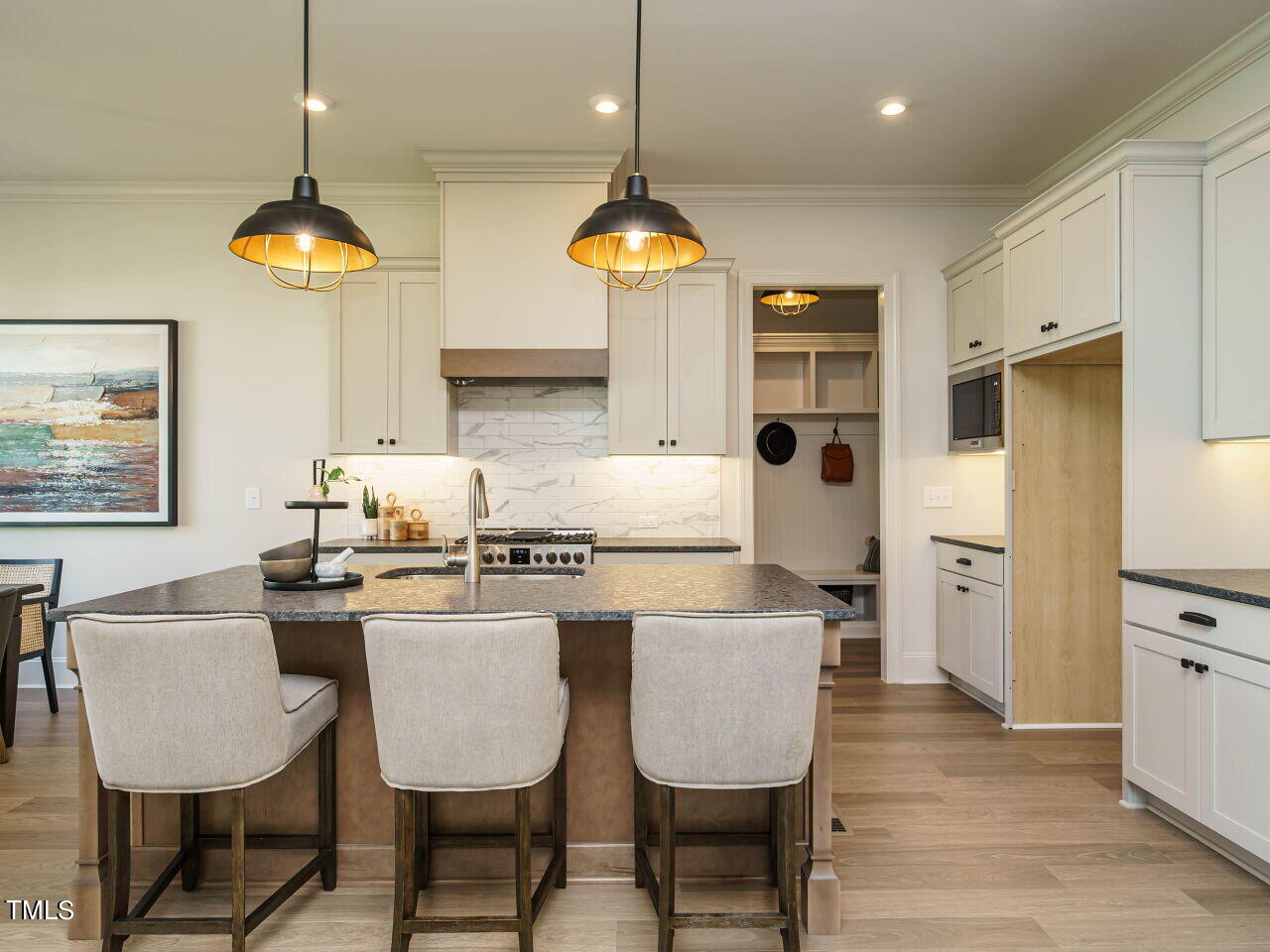 1528 Level Stream Road Wendell, NC 27591 - Photo 7 of 46 a kitchen with stainless steel appliances granite countertop a stove a refrigerator a kitchen island a dining table and chairs with wooden floor