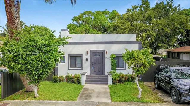 a front view of a house with garden