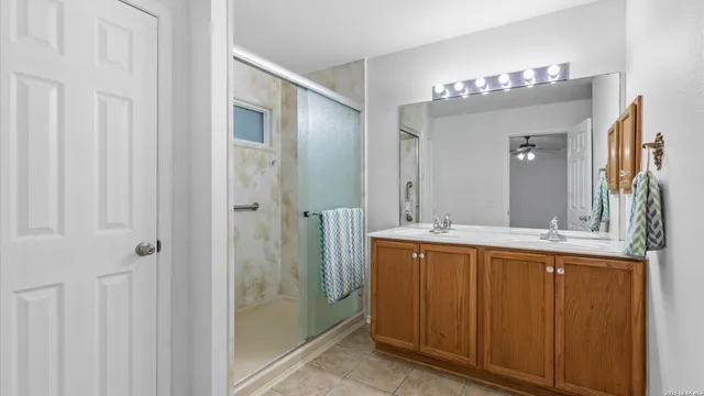 a bathroom with a double vanity sink and mirror