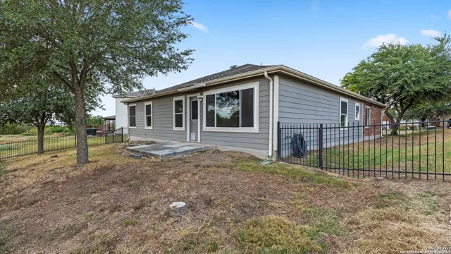 a view of a house with a small yard and plants