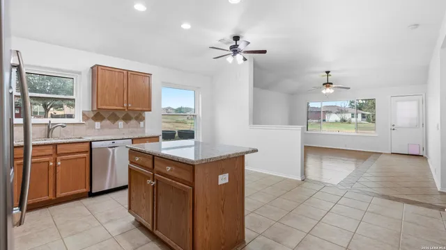 a kitchen with a stove a sink and a refrigerator