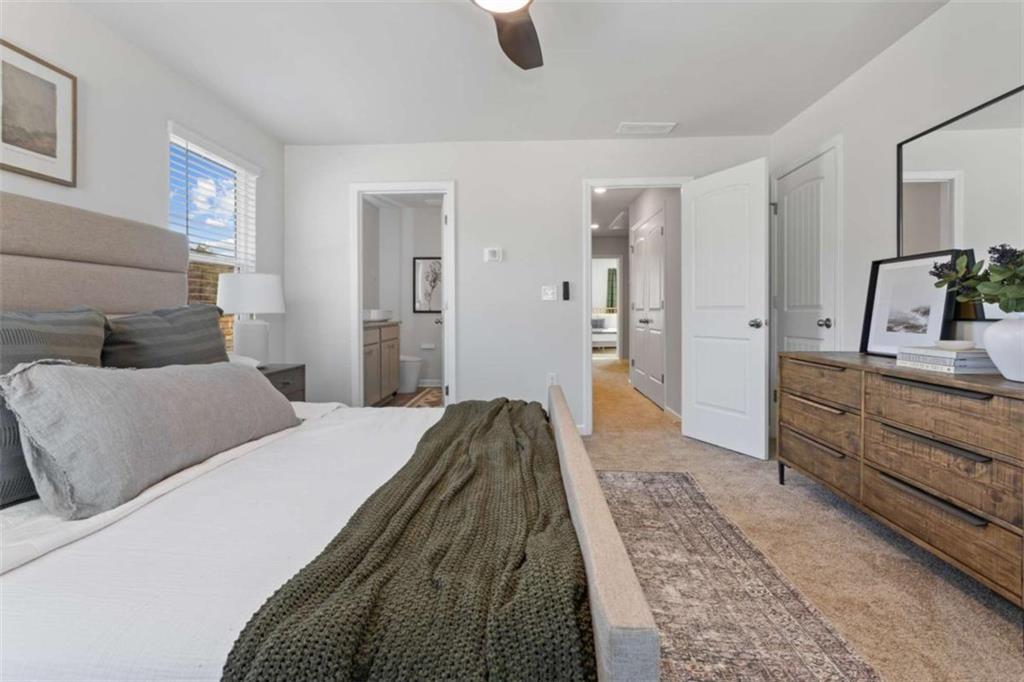 126 Meadowview Drive, Unit 13 Temple, GA 30179 - Photo 20 of 26 a bedroom with a bed and a couch