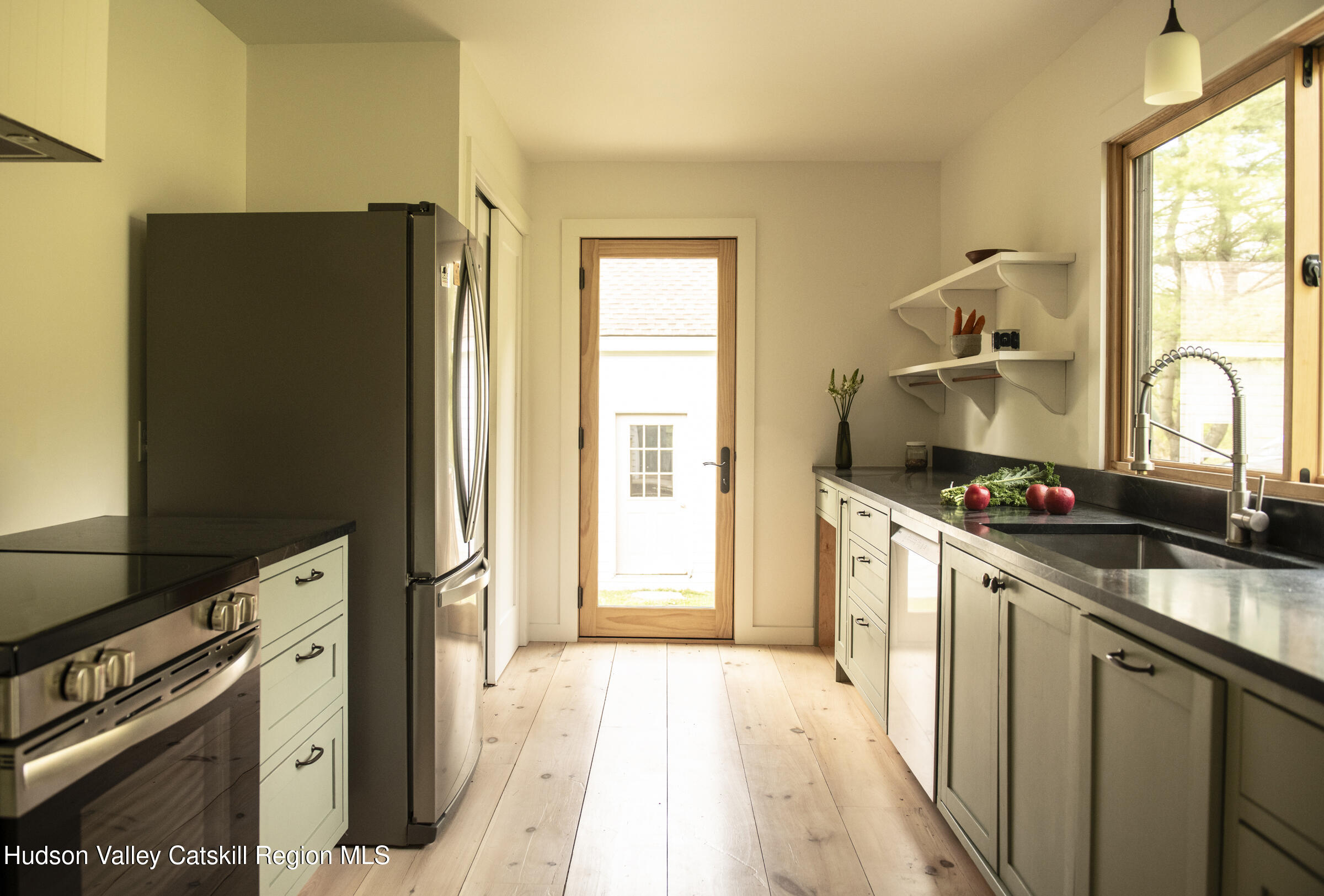 61 Schoolhouse Road New Lebanon, NY 12125 - Photo 10 of 22 a kitchen with granite countertop a refrigerator and a sink