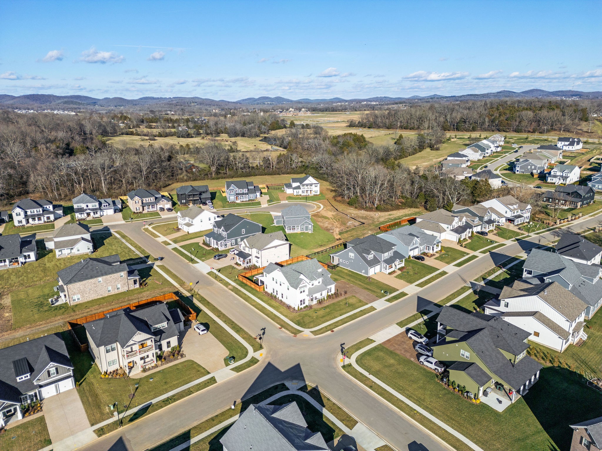 1052 Pine Creek Drive Arrington, TN 37014 - Photo 44 of 54 an aerial view of a city with lots of residential buildings and mountain view in back