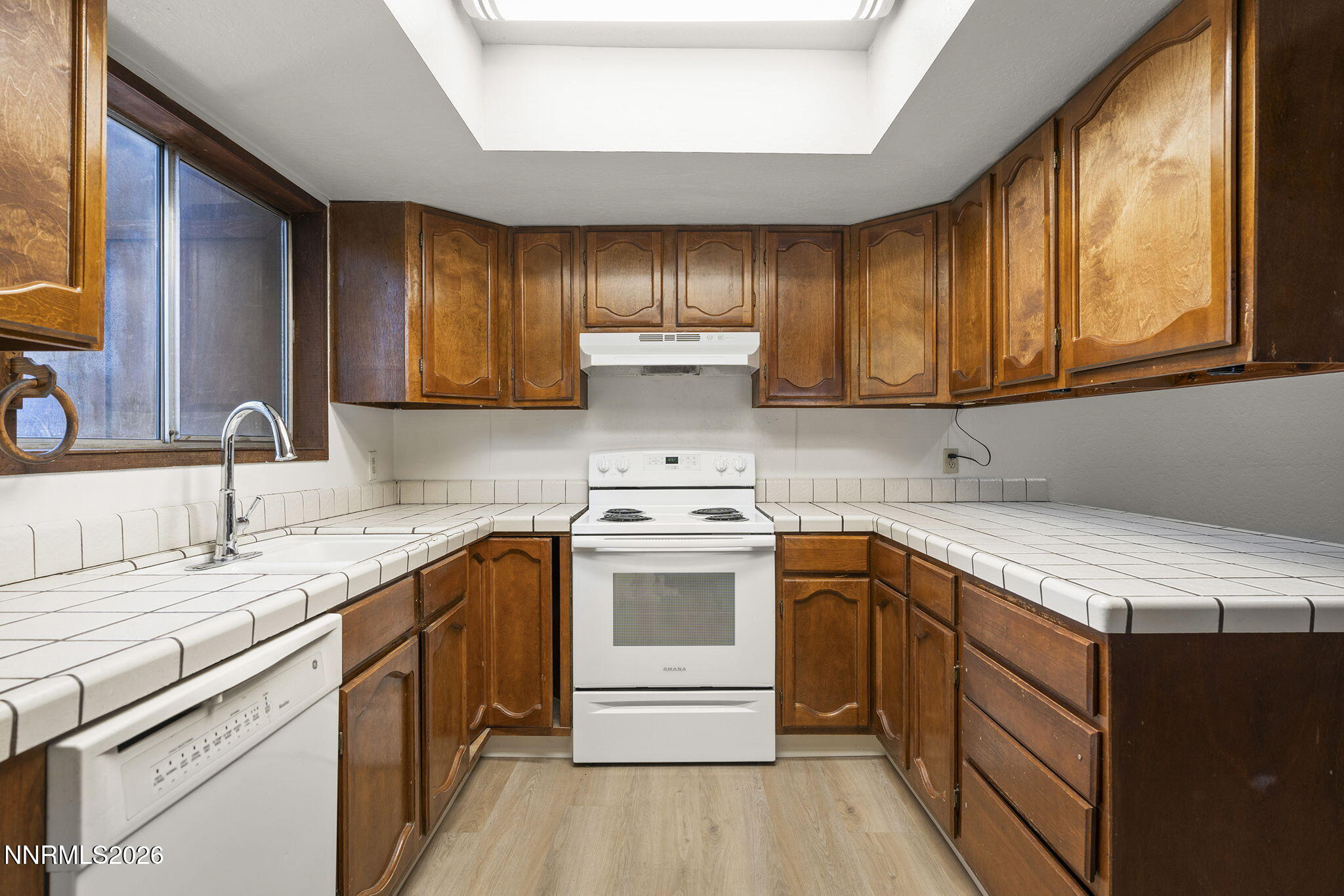 179 Tramway Drive, Unit B Stateline, NV 89449 - Photo 12 of 29 a kitchen with a sink stove and cabinets