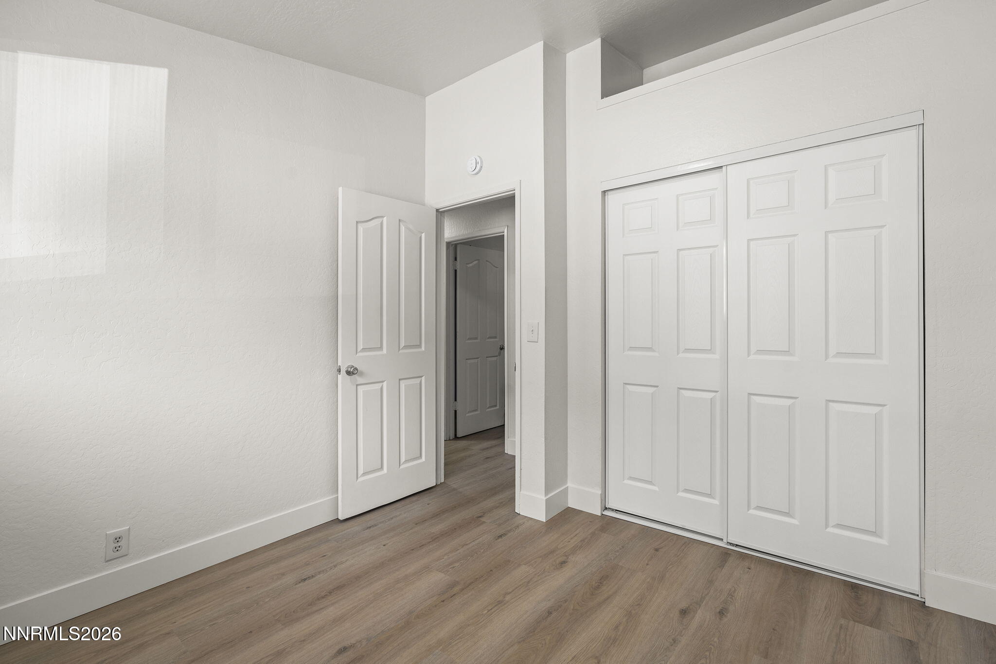 179 Tramway Drive, Unit B Stateline, NV 89449 - Photo 16 of 29 an empty room with wooden floor
