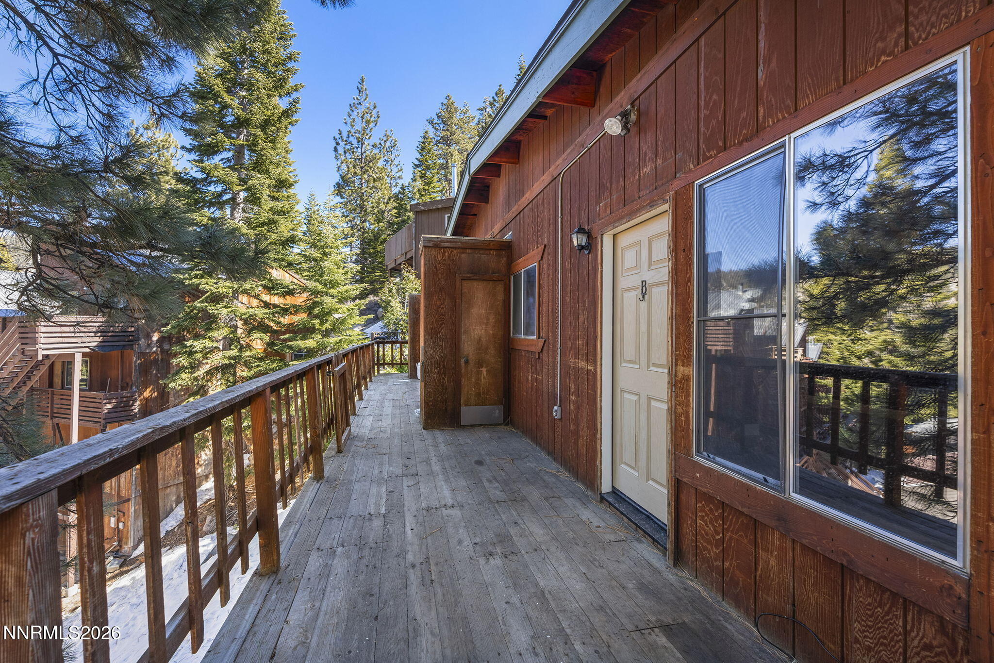 179 Tramway Drive, Unit B Stateline, NV 89449 - Photo 2 of 29 a view of a balcony with wooden floor and fence