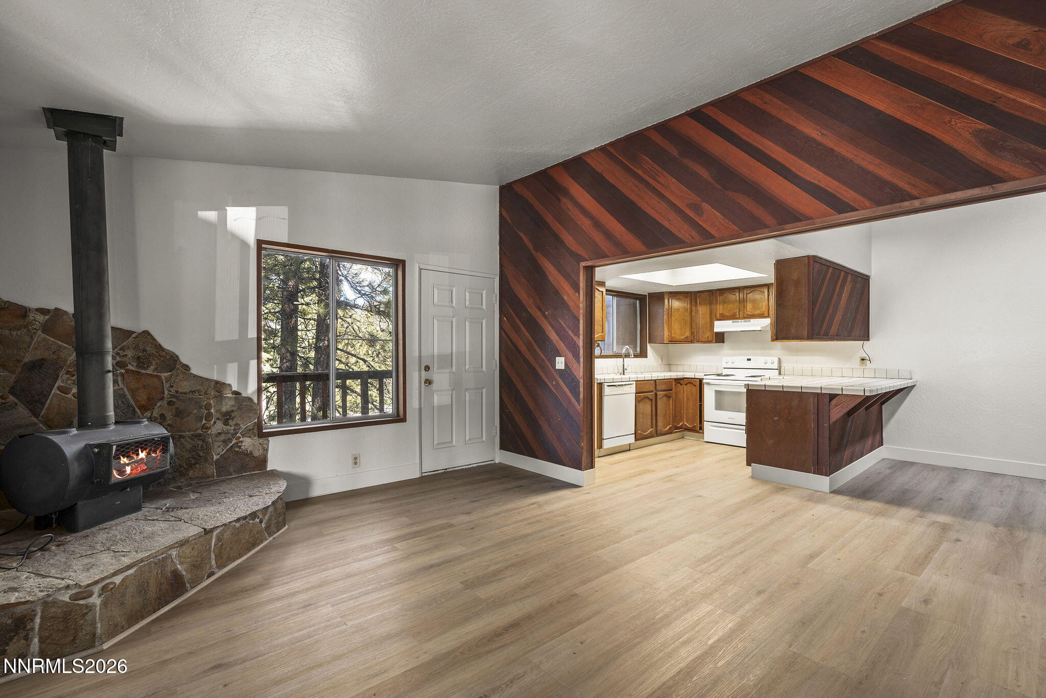 179 Tramway Drive, Unit B Stateline, NV 89449 - Photo 6 of 29 a large white kitchen with a large window a sink and a counter top space