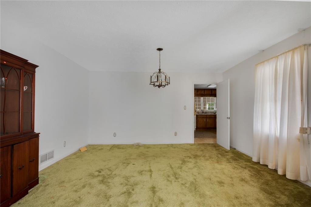 1955 Flat Shoals Road Southeast Conyers, GA 30013 - Photo 11 of 56 an empty room with windows