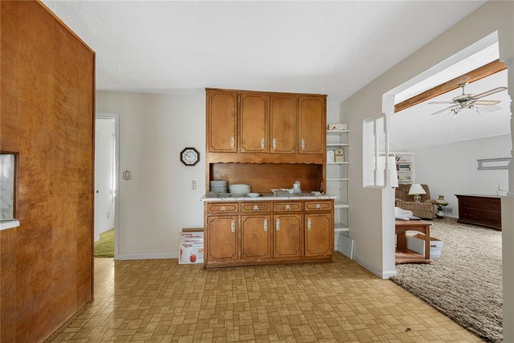 1955 Flat Shoals Road Southeast Conyers, GA 30013 - Photo 15 of 56 a kitchen with stainless steel appliances granite countertop a sink stove and refrigerator