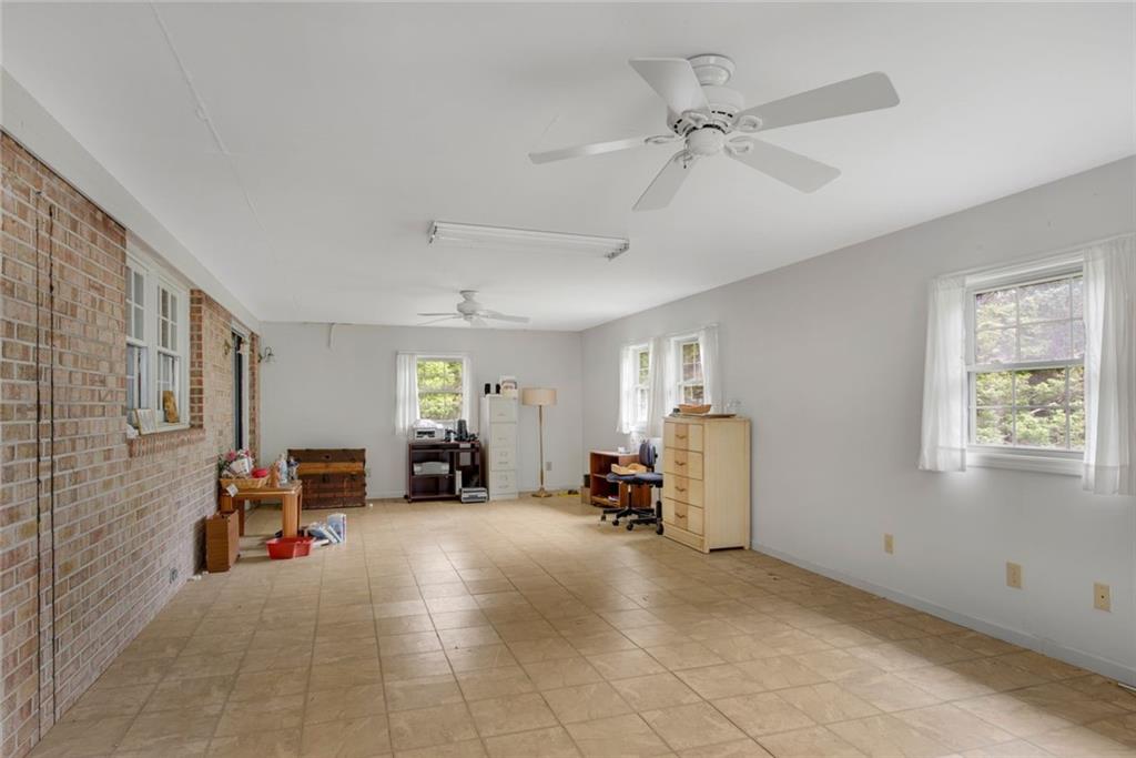 1955 Flat Shoals Road Southeast Conyers, GA 30013 - Photo 24 of 56 a view of a livingroom with furniture and a ceiling fan