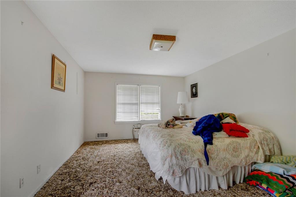 1955 Flat Shoals Road Southeast Conyers, GA 30013 - Photo 26 of 56 a bedroom with a bed and a window