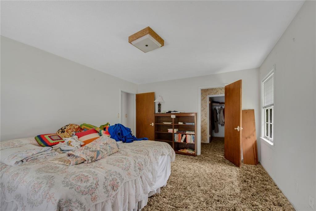 1955 Flat Shoals Road Southeast Conyers, GA 30013 - Photo 27 of 56 a bedroom with a bed and dresser
