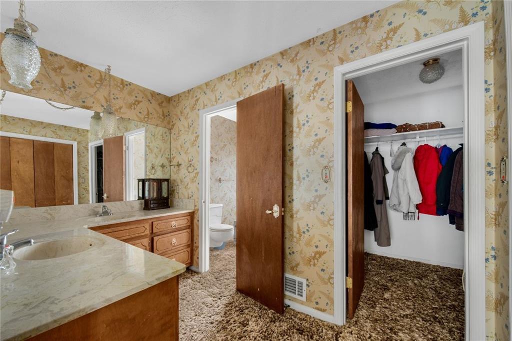 1955 Flat Shoals Road Southeast Conyers, GA 30013 - Photo 28 of 56 a view of a bathroom sink and a mirror