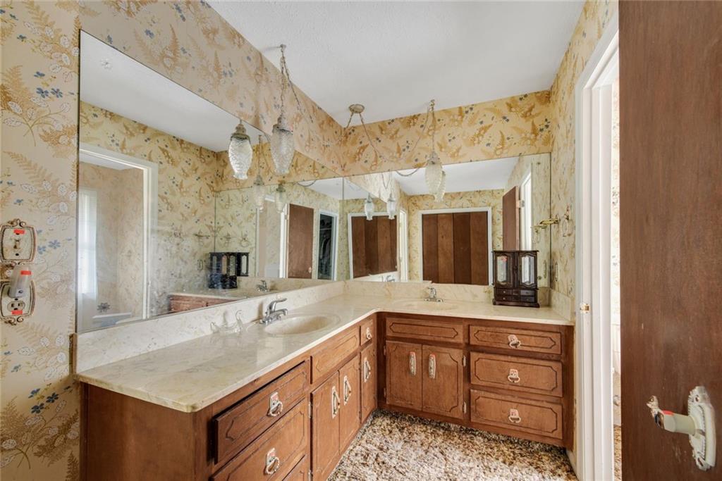 1955 Flat Shoals Road Southeast Conyers, GA 30013 - Photo 29 of 56 a bathroom with a granite countertop sink and a mirror