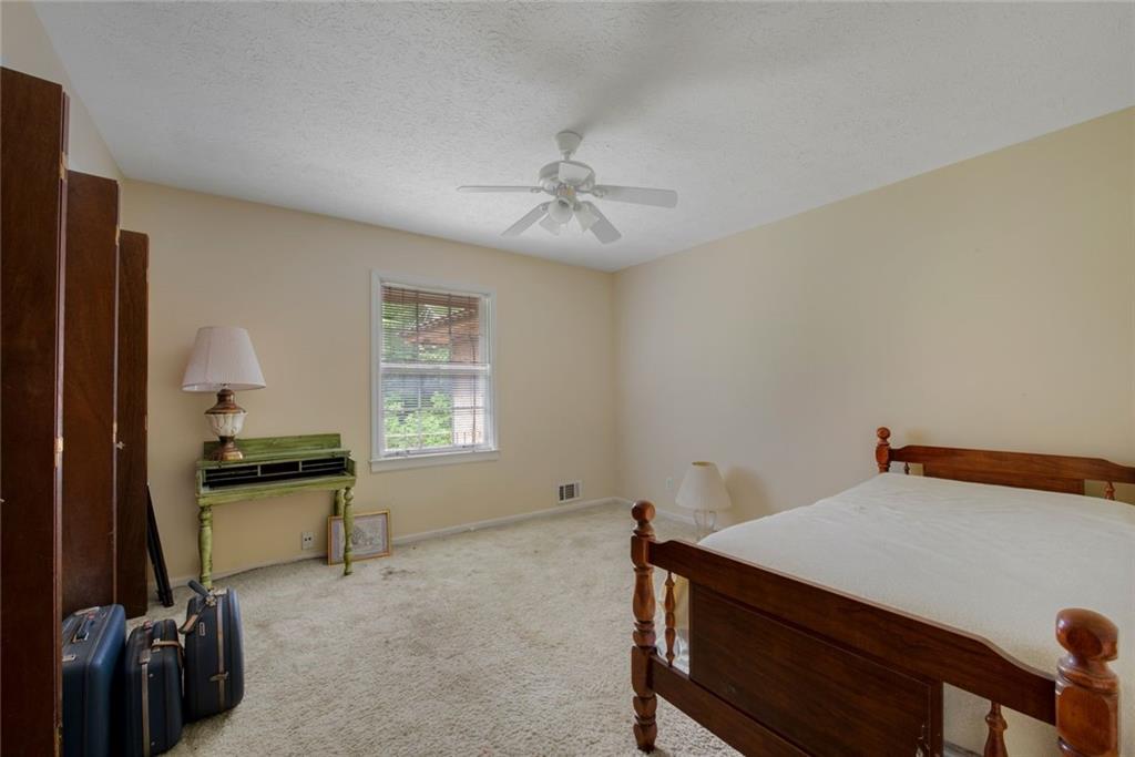 1955 Flat Shoals Road Southeast Conyers, GA 30013 - Photo 31 of 56 a bed room with a bed and a window
