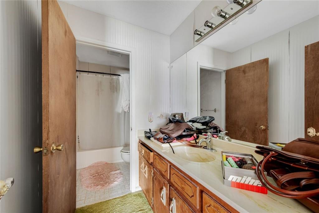 1955 Flat Shoals Road Southeast Conyers, GA 30013 - Photo 32 of 56 a bathroom with a sink and a mirror