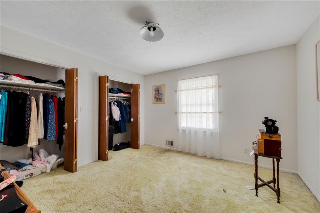 1955 Flat Shoals Road Southeast Conyers, GA 30013 - Photo 33 of 56 a bed room with a bed and a window