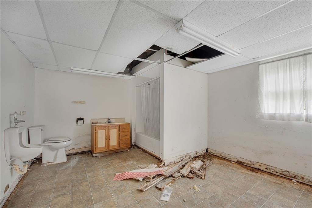 1955 Flat Shoals Road Southeast Conyers, GA 30013 - Photo 42 of 56 a bathroom with a toilet and a shower
