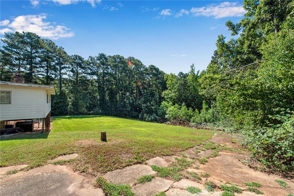 1955 Flat Shoals Road Southeast Conyers, GA 30013 - Photo 44 of 56 a view of a yard with a house in the background