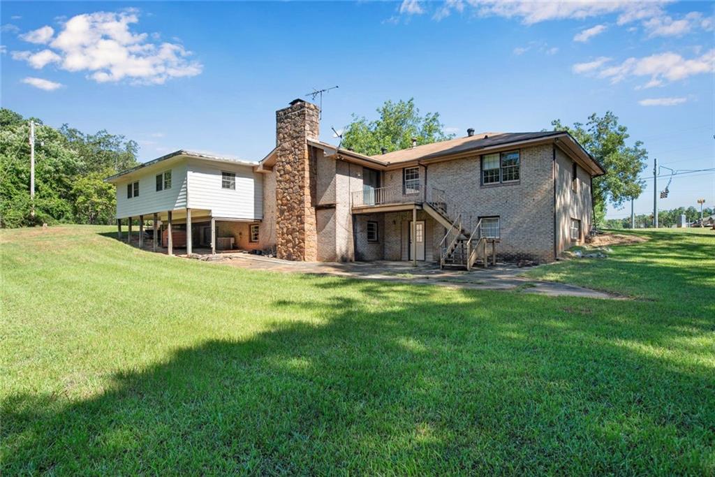 1955 Flat Shoals Road Southeast Conyers, GA 30013 - Photo 46 of 56 a house view with a sitting space and garden