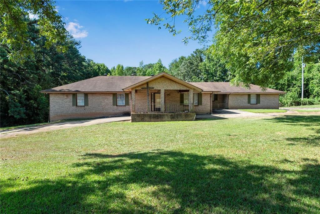 1955 Flat Shoals Road Southeast Conyers, GA 30013 - Photo 48 of 56 a front view of a house with a garden