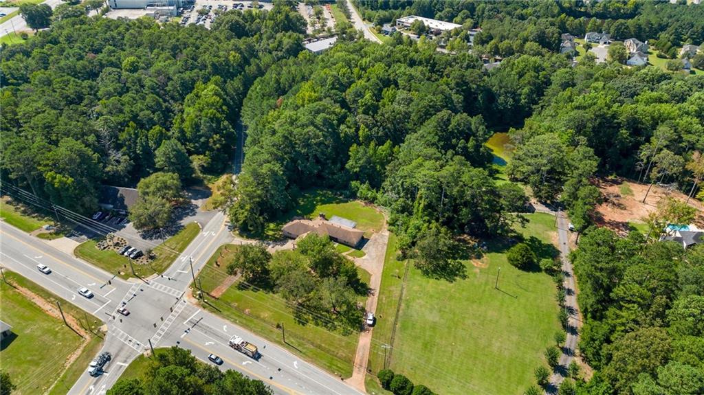 1955 Flat Shoals Road Southeast Conyers, GA 30013 - Photo 50 of 56 an aerial view of a residential houses with yard