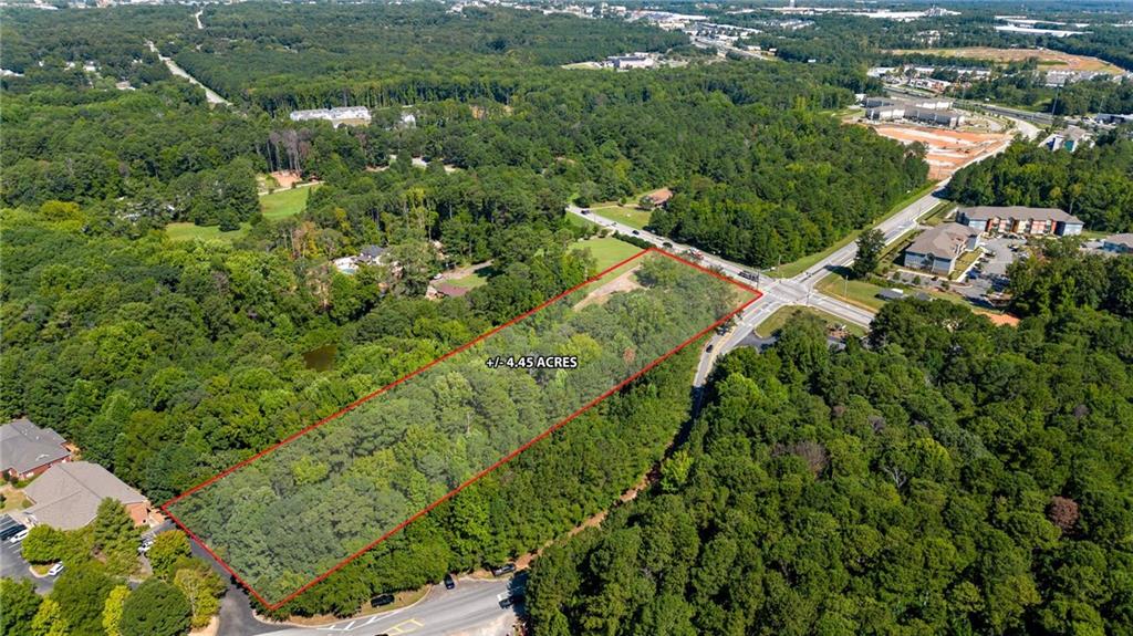 1955 Flat Shoals Road Southeast Conyers, GA 30013 - Photo 52 of 56 an aerial view of residential houses with outdoor space and trees