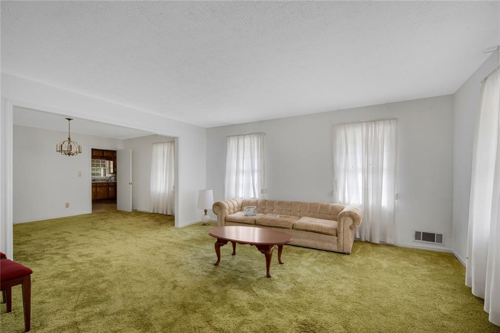 1955 Flat Shoals Road Southeast Conyers, GA 30013 - Photo 9 of 56 a living room with furniture and a window