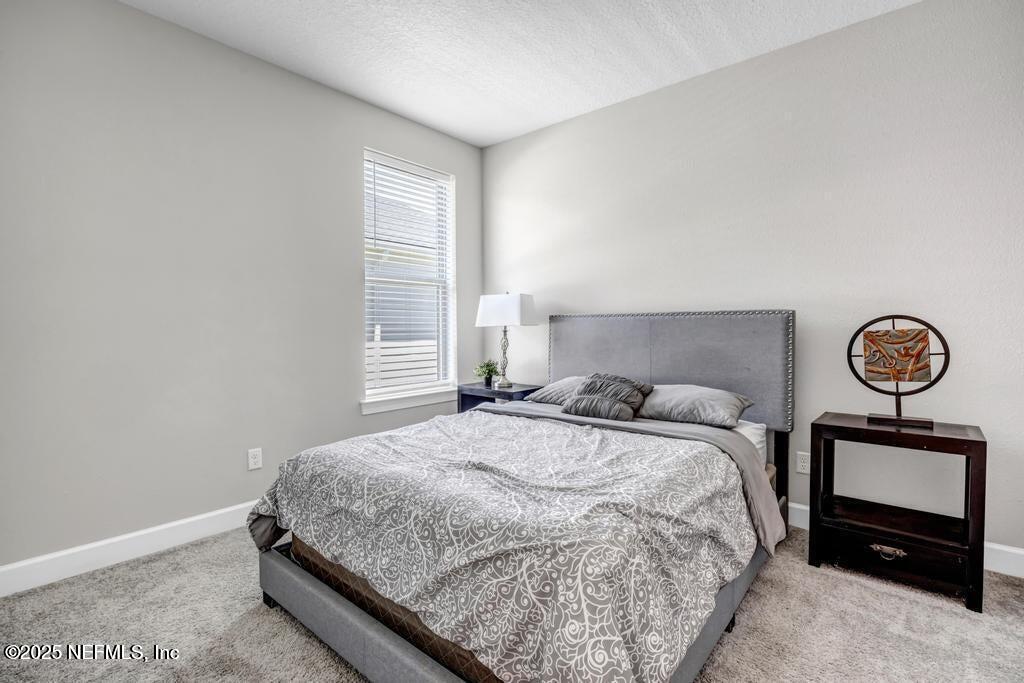 23 Catesby Lane St. Augustine, FL 32095 - Photo 13 of 31 a bedroom with a bed and a window