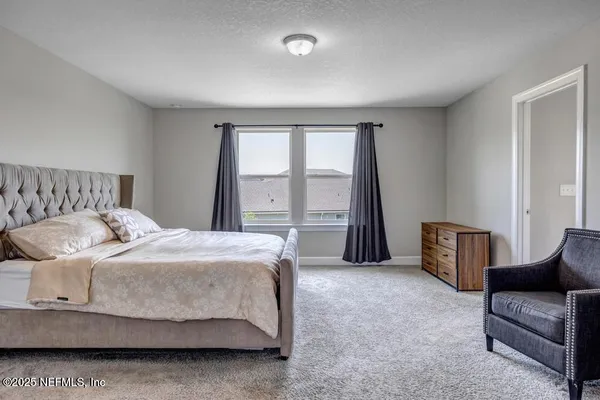 a bedroom with a bed and glass window