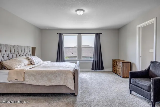 a bedroom with a bed and glass window