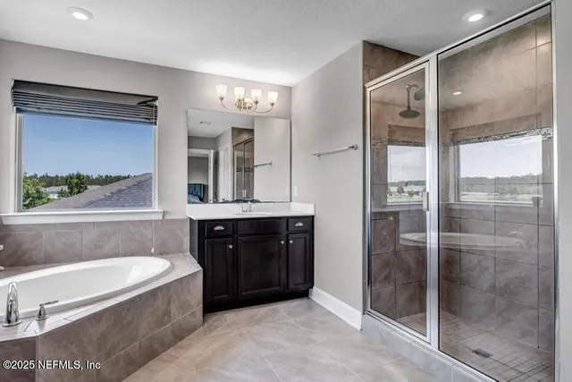 a bathroom with a bathtub sink and mirror