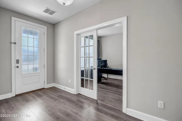 wooden floor in an empty room with a window
